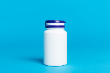 Plastic bottle for vitamins on color background