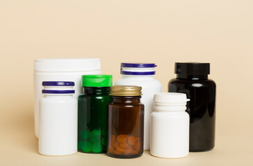 Plastic bottles for vitamins on color background