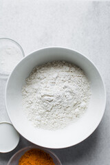 All purpose flour in a white bowl, baking flour in a large bowl