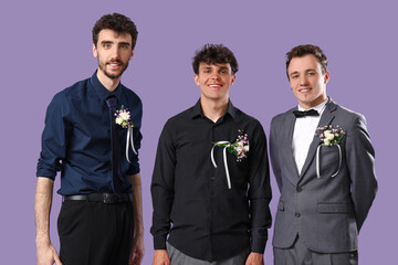 Young men dressed for prom on lilac background