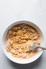 Loosely folded bread dough in a white bowl, bread dough, low hydration dough, process of making bread
