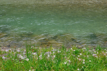 Abstract image pattern of a mountain river with fast water. Rapid flow of a mountain river in spring, close-up.