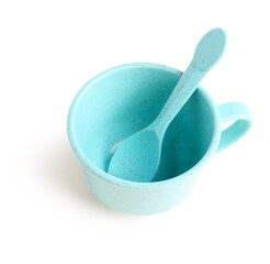 Blue cup with spoon isolated on white background. Children's Day celebration