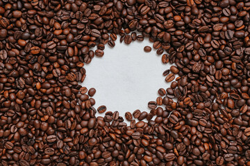 Frame made of coffee beans on light background