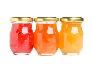 Jars of different jams on white background