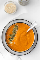 A plate with pumpkin soup puree, pumpkin and sesame seeds. Autumn menu. 