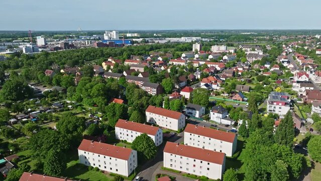Drone shot of a neighbourhood in Minden town , a middle-sized town in the very north-east of North Rhine-Westphalia, Germany, . Flying over houses and trees .