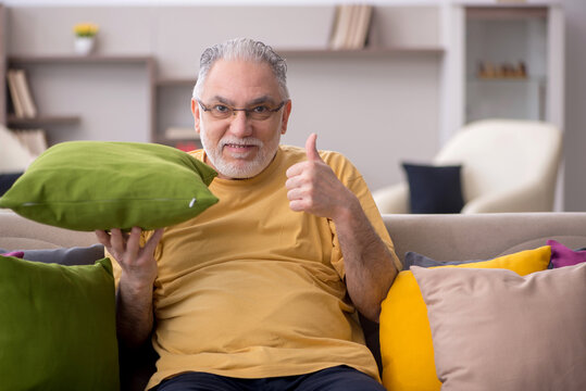 Old man with many pillows at home