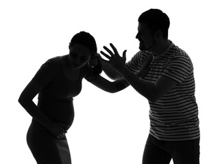 Silhouette of man beating his pregnant wife on white background. Domestic violence concept