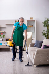 Old male contractor cleaning the house