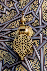 Detail of the elaborate and elegant Moorish style knocker on the main gate of the Royal Palace of...