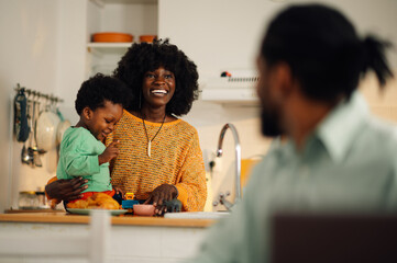 A happy multicultural family at home in the morning.