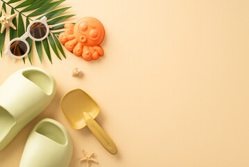 Peaceful beach vacation with infant. Top view composition showcasing playthings, sandcastle accessories, shades, comfy slippers, shell, starfish, palm leaf, calming beige surface. Great for text or ad
