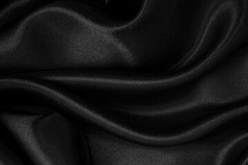 Obraz premium Smooth elegant black silk or satin luxury cloth texture as abstract background. Luxurious background design