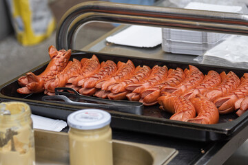 Roasted sausages on a baking sheet.