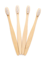 Many bamboo toothbrushes on white background