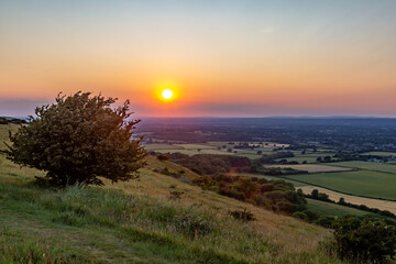 Looking out over fields in Sussex from Ditchling Beacon at sunset