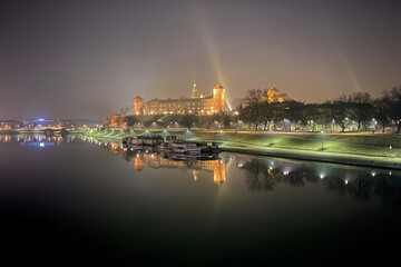 Fototapeta na wymiar Scenic view of Krakow, Poland with Wawel Royal Castle and its reflection in Vistula River