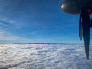 Naklejka na ściany i meble Aerial of cloud cover with a propeller of an airplane