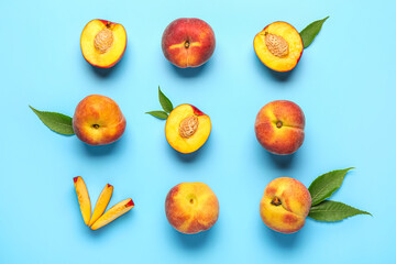 Sweet peaches and leaves on blue background