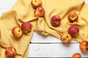 Sweet peaches on white wooden background