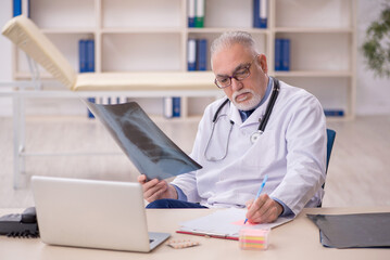 Fototapeta premium Old male doctor radiologist working in the clinic