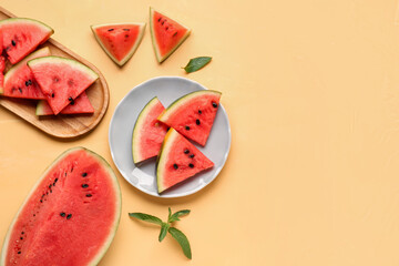 Plate and board with pieces of fresh watermelon on yellow background