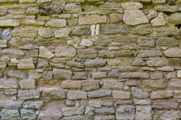 Rough texture wall made of blocks of natural stone. Background or backdrop. Blank for design, graphic resource