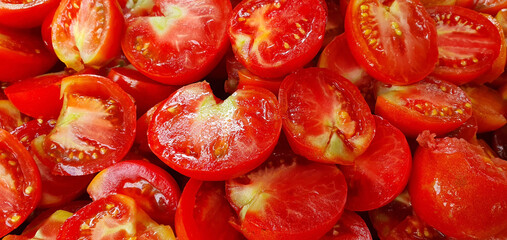 A tantalizing symphony of vibrant, crimson halved tomatoes, brimming with nature's bounty, enticing...