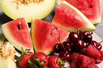 Plate with pieces of fresh watermelon and different berries, closeup