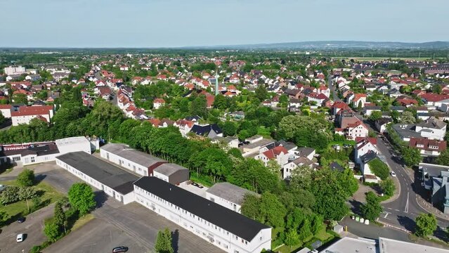 Drone shot of a neighbourhood in Minden town , a middle-sized town in the very north-east of North Rhine-Westphalia, Germany, . Flying over houses and trees .