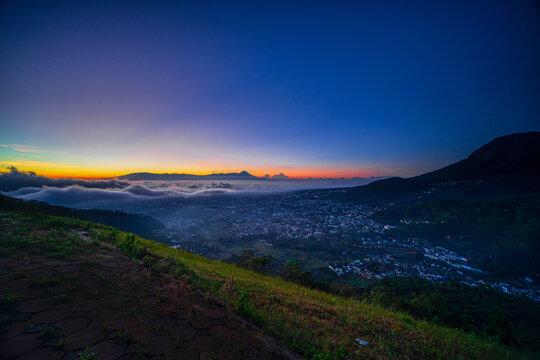View of the sunrise on the paralayang hill of Batu City