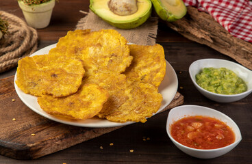 unhealthy snack based on fried plantain slices with Spanish sofrito © sebastian