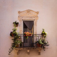 Beautiful balcony adorned with flowers and plants in an historic baroque palace, Ostuni, Brindisi,...