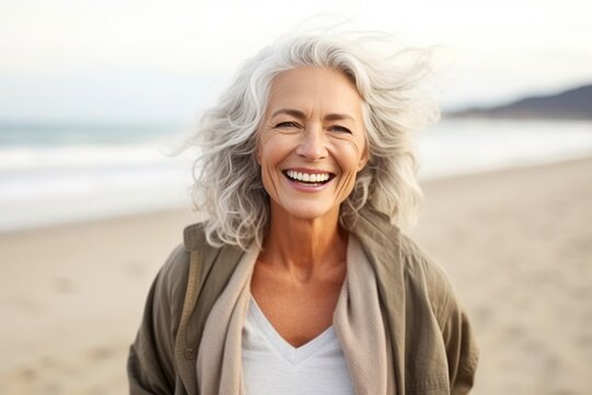 Smiling Attractive Beautiful Caucasian Senior Mature Woman Posing At The Beach Looking At The Camera