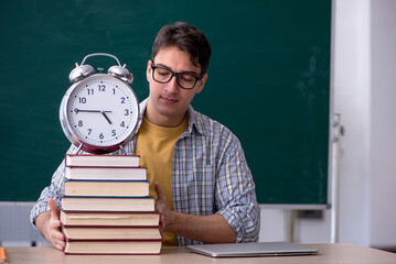 Young male student in time management concept