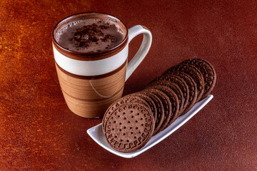 Cup of milk with cocoa and chocolate biscuits