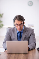 Young male employee working in the office