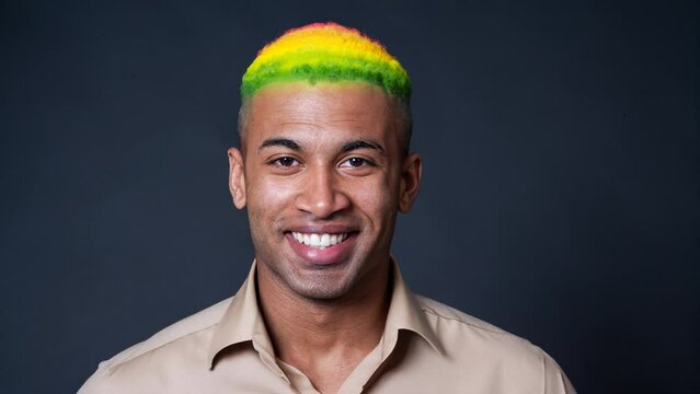 Handsome young African American man with constantly morphing rainbow afro hairstyle