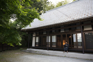 古民家の縁側で日本酒など晩酌などを楽しむ人　広角のコピースペース	