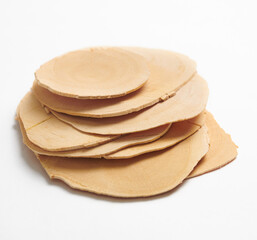 Drid and sliced tongkat-ali, long jack, isolated on white background. Selective focus