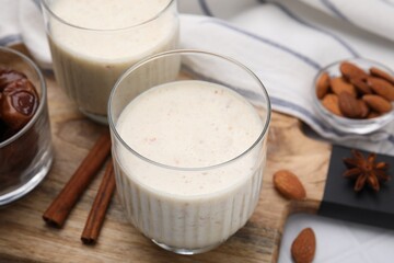 Glasses of delicious date smoothie on table, closeup