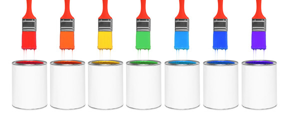 Brushes with colorful paints in air over cans on white background