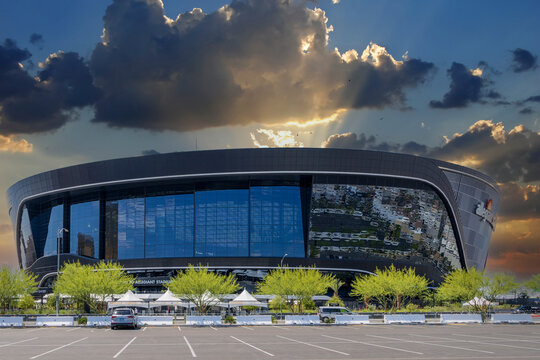 A gorgeous spring landscape at Allegiant Stadium surrounded by lush green trees and plants and powerful clouds at sunset in Las Vegas Nevada USA
