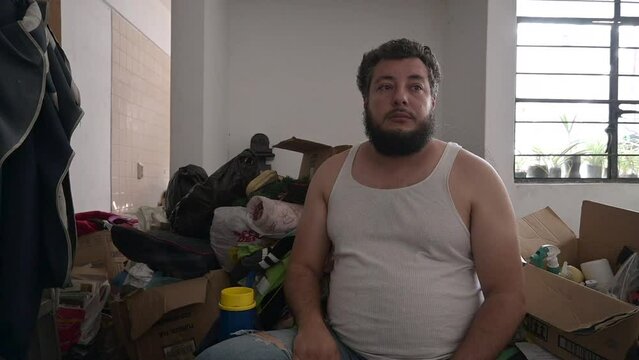depressed person with hoarding syndrome close up in messy room