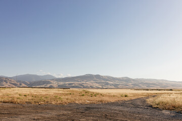 Sunny summer landscape in California. Scenic landscape with mountains, yellow grass in the foreground, clear sky on a sunny day.