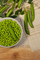 Juicy green peas in pods and grains. Close-up.