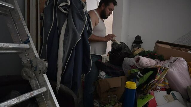 4k video of person with hoarding disorder in a dirty room. mental health care concept