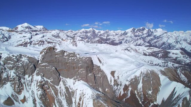 Aerial birds eye view Himalaya mountains snowy peaks and blue skies in sunny summer day. Majestic breathtaking mountains trekking Asia.Tilicho base camp route, Manang, Nepal