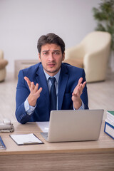 Young male employee working in the office